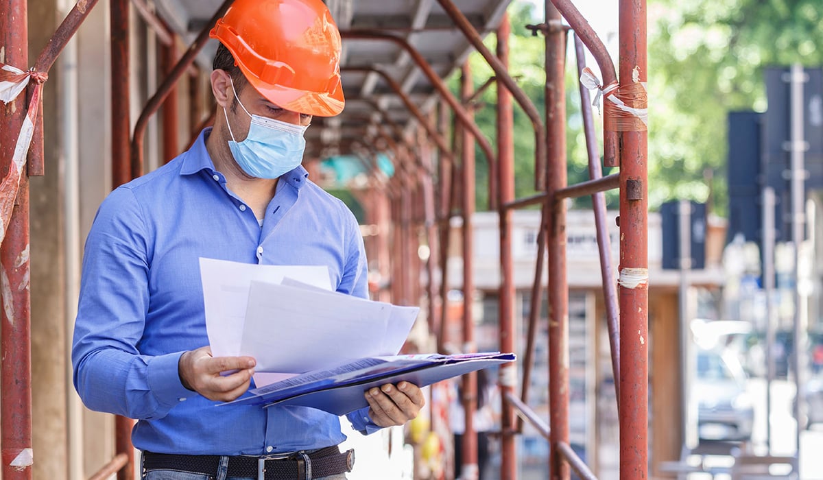 Construction worker viewing documents