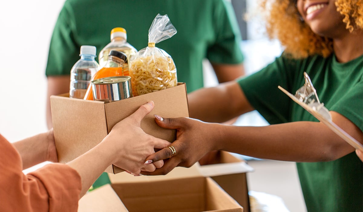 Volunteer handling box of food