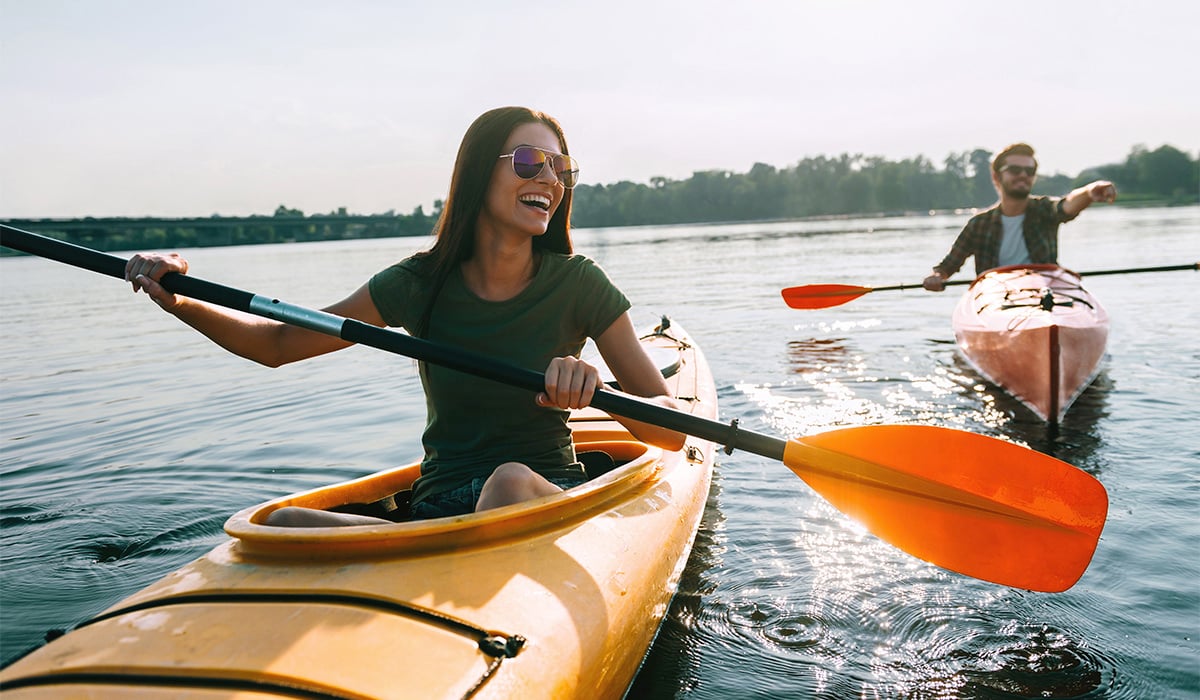 Couple kayaking on calm lake