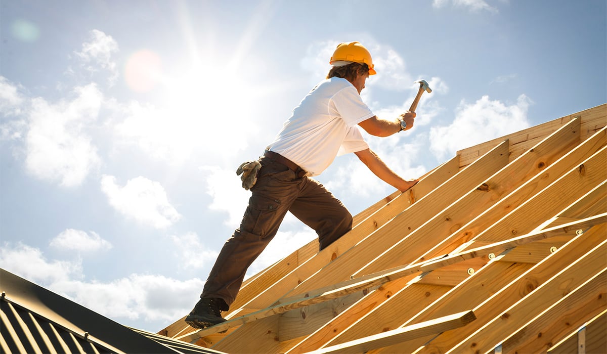 Construction worker building a roof