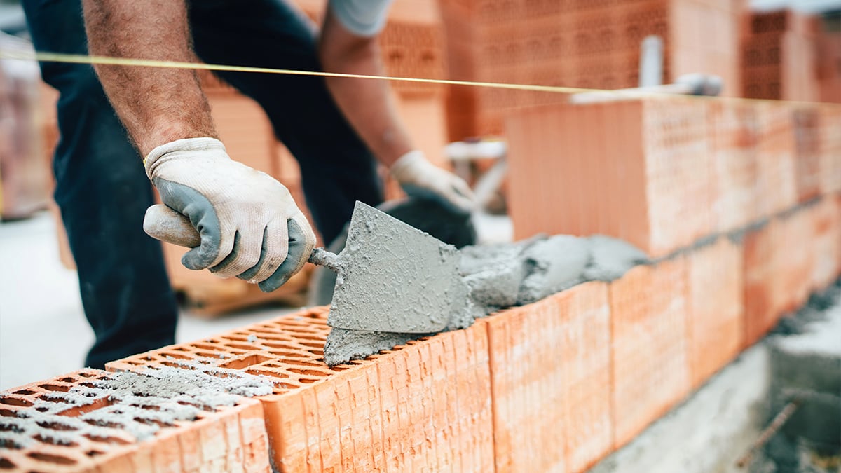 Construction worker laying bricks