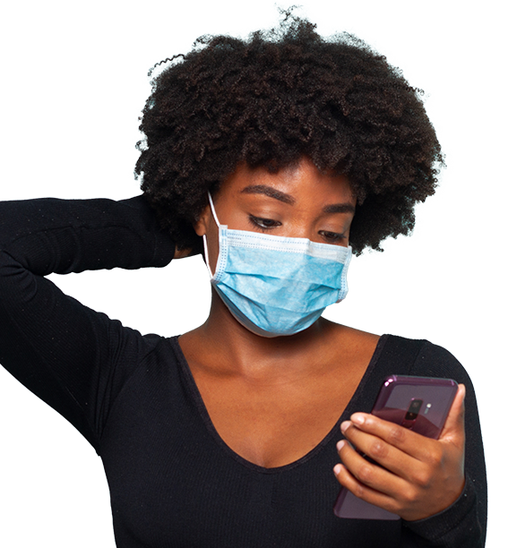 Woman in face mask using phone