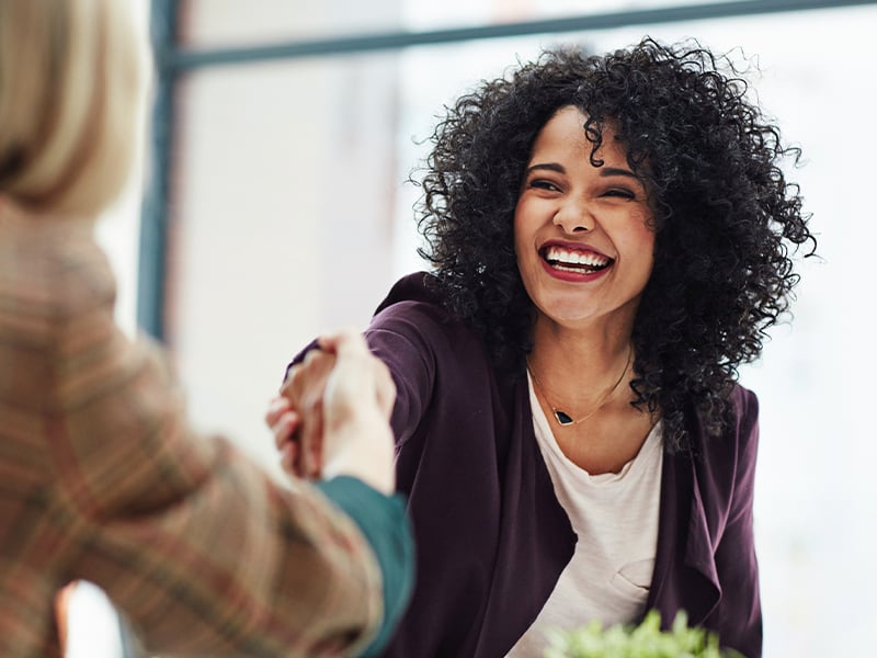 Business women shaking hands