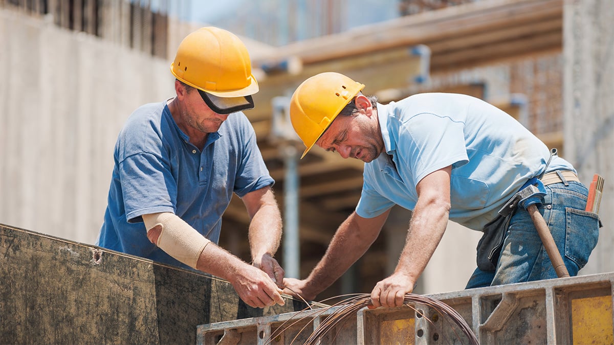 Two construction workers on build site